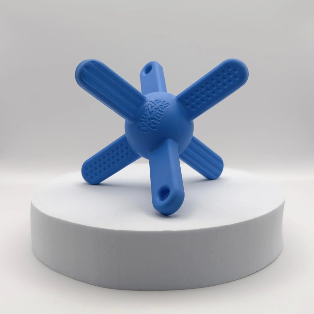 Blue Muzzle Mate dog toy – a lightweight, muzzle-friendly fetch toy with six arms off a centre ball, designed for dogs to pick up and carry while wearing a muzzle